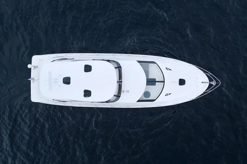 Why Knot Yacht Photos Pics Aerial view of 2013 Meridian 441 Sedan yacht on open water.