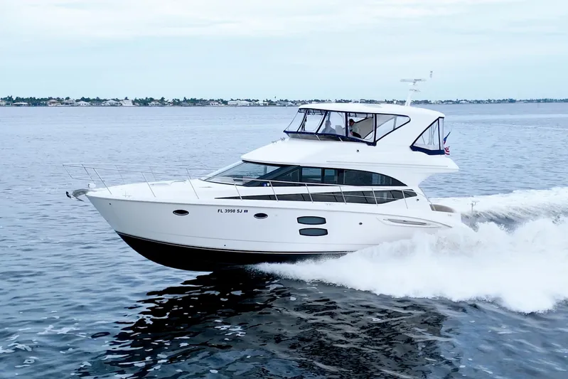 Why Knot Yacht Photos Pics 2013 Meridian 441 Sedan yacht cruising on open water, showcasing sleek design and performance.