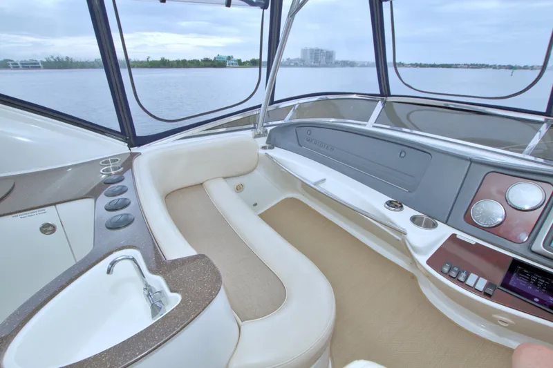 Why Knot Yacht Photos Pics Interior of 2013 Meridian 441 Sedan yacht with luxurious seating and control panel.