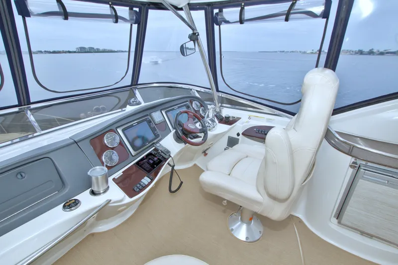 Why Knot Yacht Photos Pics Helm of 2013 Meridian 441 Sedan yacht with luxurious seating and navigation equipment.