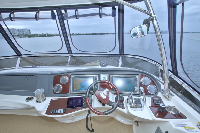 Why Knot Yacht Photos Pics Helm of 2013 Meridian 441 Sedan yacht with navigation screens and steering wheel.