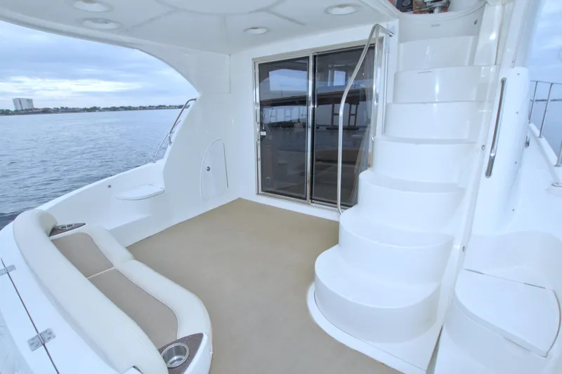 Why Knot Yacht Photos Pics 2013 Meridian 441 Sedan yacht interior with stairs and seating, overlooking water.
