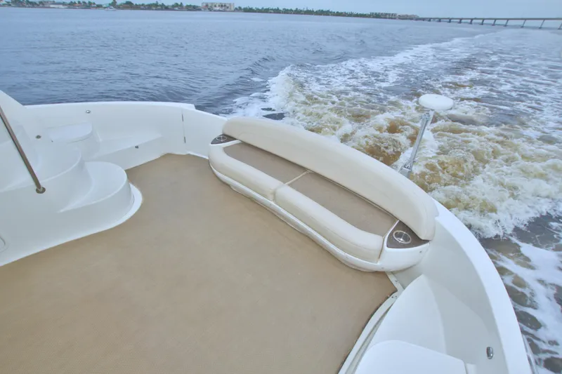Why Knot Yacht Photos Pics 2013 Meridian 441 Sedan yacht deck with seating, cruising on open water.
