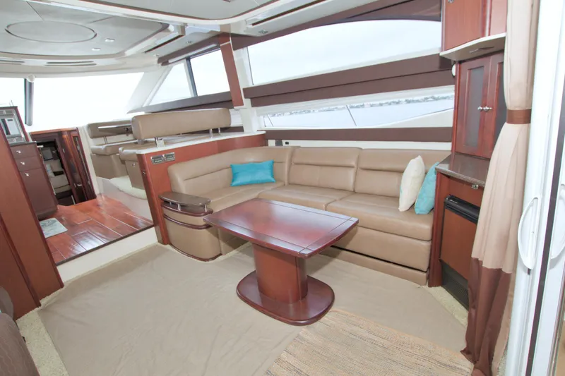 Why Knot Yacht Photos Pics Luxurious interior of 2013 Meridian 441 Sedan yacht with leather seating and wooden accents.