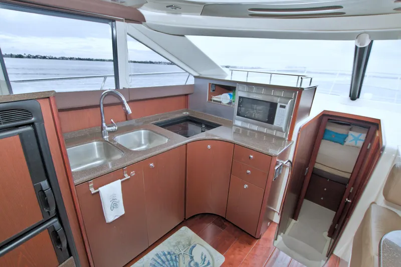 Why Knot Yacht Photos Pics Luxurious 2013 Meridian 441 Sedan yacht kitchen with modern amenities and scenic water view.
