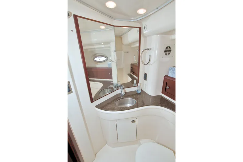 Why Knot Yacht Photos Pics Bathroom interior of 2013 Meridian 441 Sedan yacht, featuring sink and mirror.