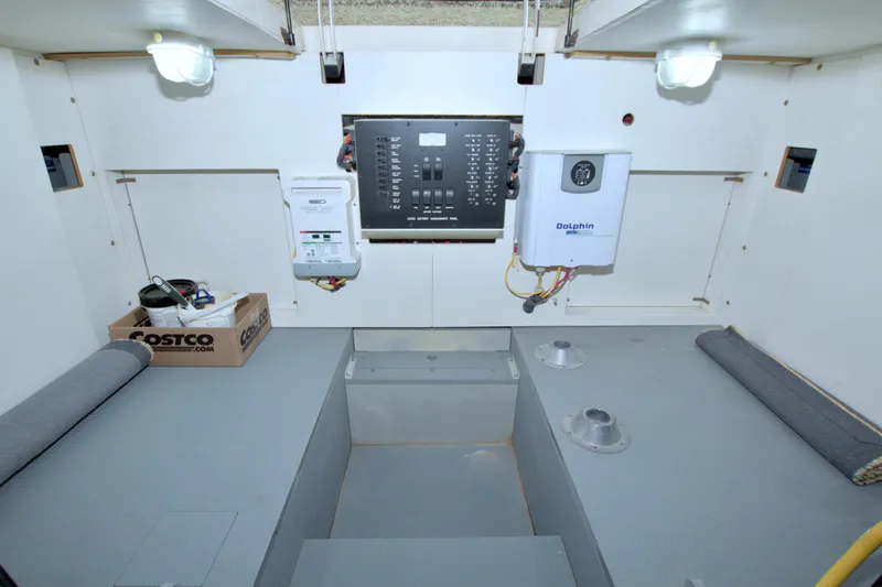 Why Knot Yacht Photos Pics Engine room of 2013 Meridian 441 Sedan with control panel and storage.