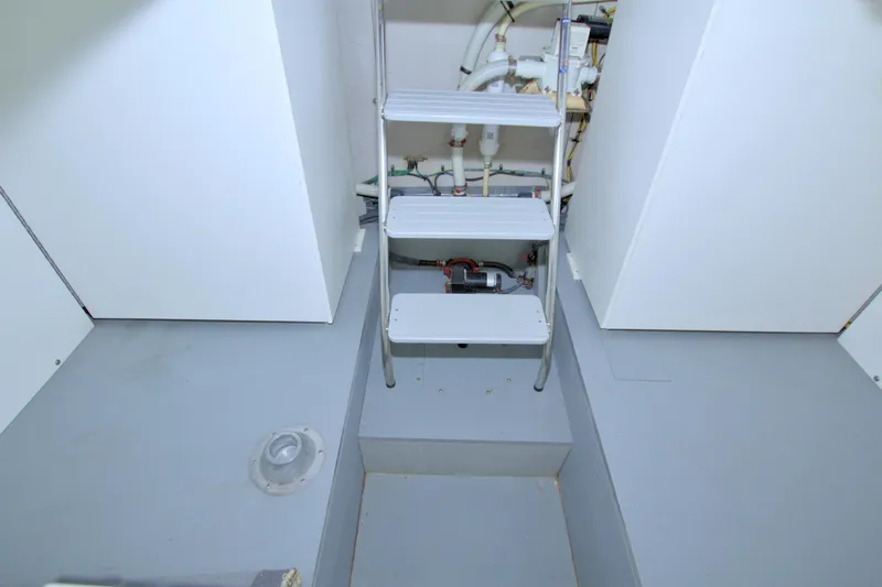 Why Knot Yacht Photos Pics Engine room of 2013 Meridian 441 Sedan with ladder and visible piping.