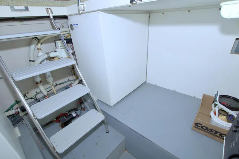 Why Knot Yacht Photos Pics Engine room of 2013 Meridian 441 Sedan yacht with ladder and storage.