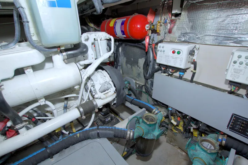 Why Knot Yacht Photos Pics Engine room of 2013 Meridian 441 Sedan with mechanical components and fire extinguisher.