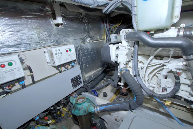 Why Knot Yacht Photos Pics Engine room of a 2013 Meridian 441 Sedan yacht, showcasing mechanical components and wiring.