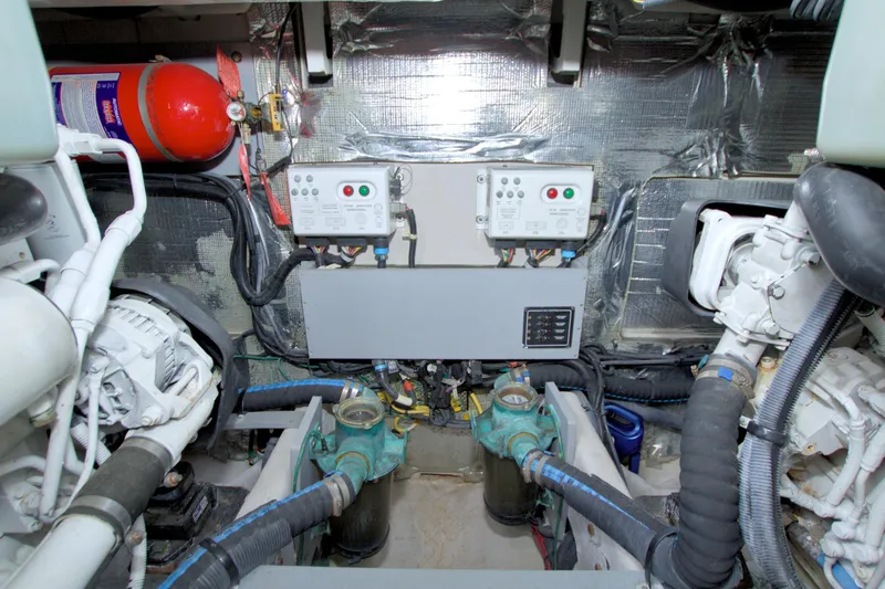 Why Knot Yacht Photos Pics Engine room of 2013 Meridian 441 Sedan with control panels and fire extinguisher.