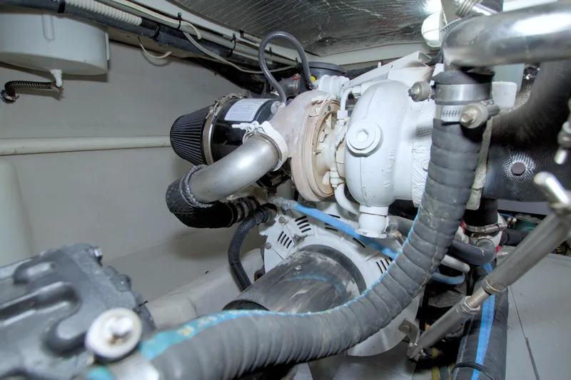 Why Knot Yacht Photos Pics Engine room of 2013 Meridian 441 Sedan yacht, showcasing mechanical components and piping.