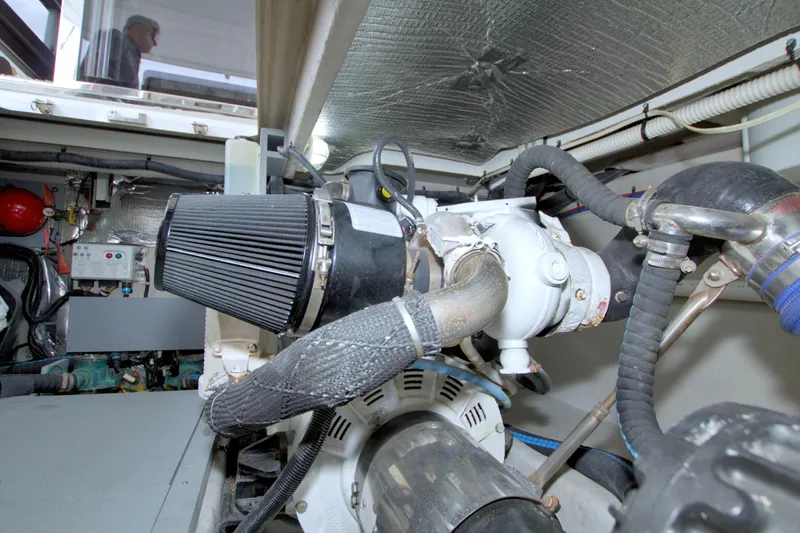 Why Knot Yacht Photos Pics Engine room of a 2013 Meridian 441 Sedan yacht, showcasing mechanical components.