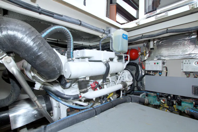 Why Knot Yacht Photos Pics Engine room of 2013 Meridian 441 Sedan yacht, showcasing mechanical components and systems.