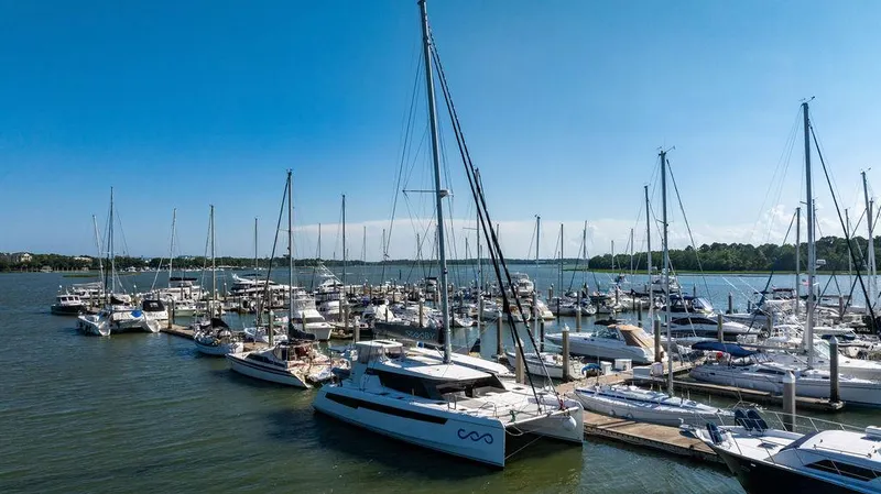 Scooby Yacht Photos Pics Marina with various sailboats, including a 2022 Leopard 50, under a clear blue sky.