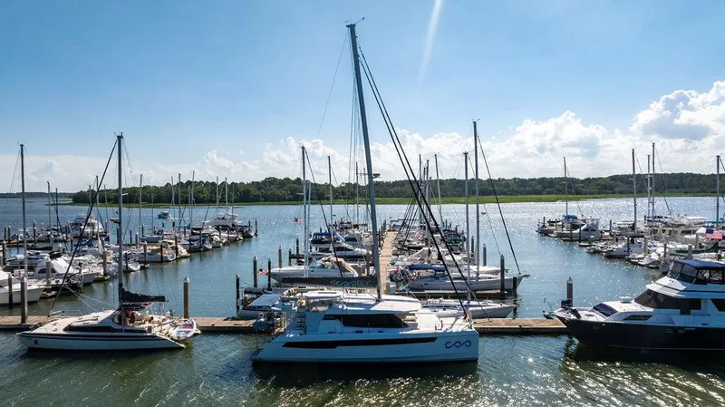 Scooby Yacht Photos Pics Marina with Leopard 50 yacht, 2022 model, docked among various boats under a clear blue sky.