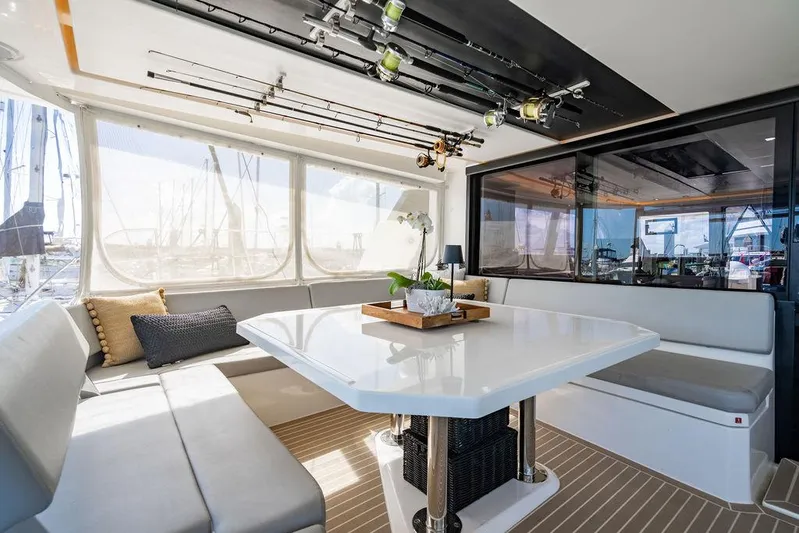 Scooby Yacht Photos Pics Luxurious Leopard 50 yacht interior with dining area, fishing rods, and panoramic windows, 2022 model.