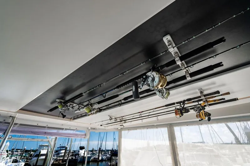 Scooby Yacht Photos Pics Fishing rods stored on a 2022 Leopard 50 yacht, with marina view in background.