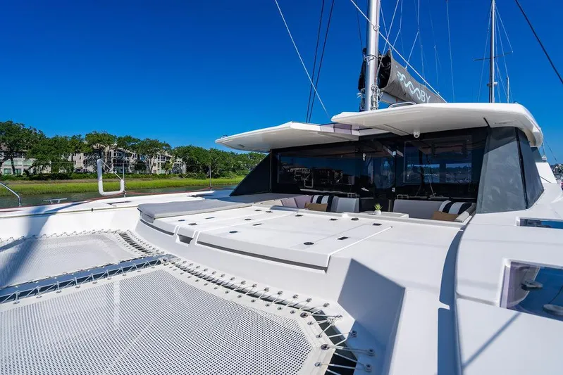 Scooby Yacht Photos Pics Luxury Leopard 50 catamaran, 2022 model, with spacious deck and sleek design under clear blue sky.