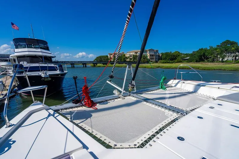 Scooby Yacht Photos Pics Catamaran deck view with ropes, docked near a yacht, clear blue sky, Leopard 50, 2022 model.