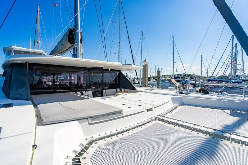 Scooby Yacht Photos Pics 2022 Leopard 50 catamaran docked at marina, featuring spacious deck and modern design.