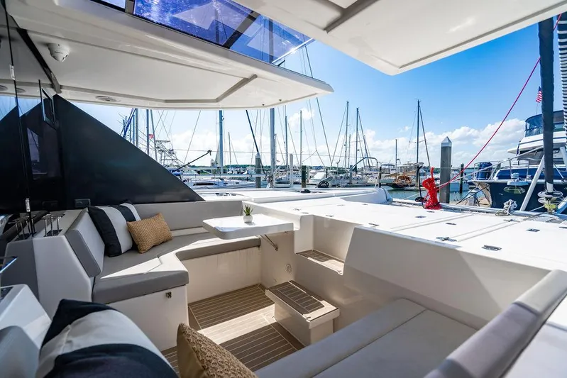 Scooby Yacht Photos Pics Luxurious Leopard 50 yacht interior with marina view, featuring comfortable seating and modern design, 2022 model.