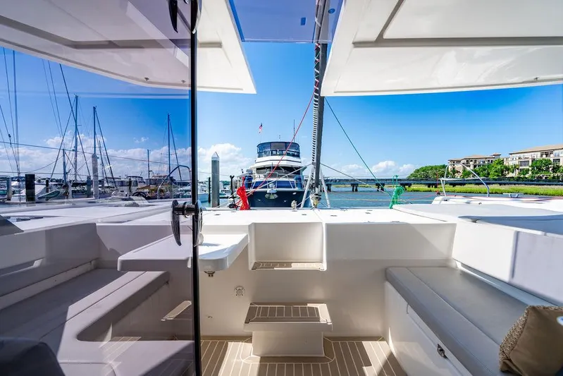 Scooby Yacht Photos Pics 2022 Leopard 50 yacht interior with marina view, featuring sleek seating and modern design.