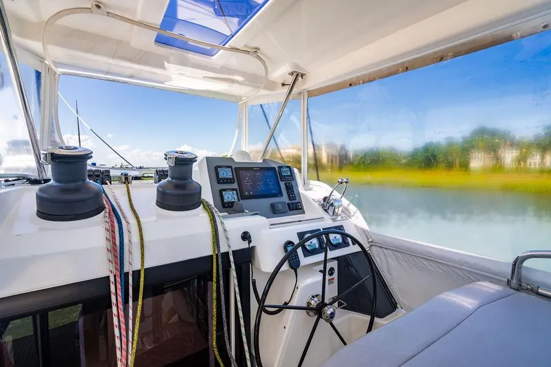 Scooby Yacht Photos Pics Interior of 2022 Leopard 50 yacht cockpit with navigation equipment and steering wheel.