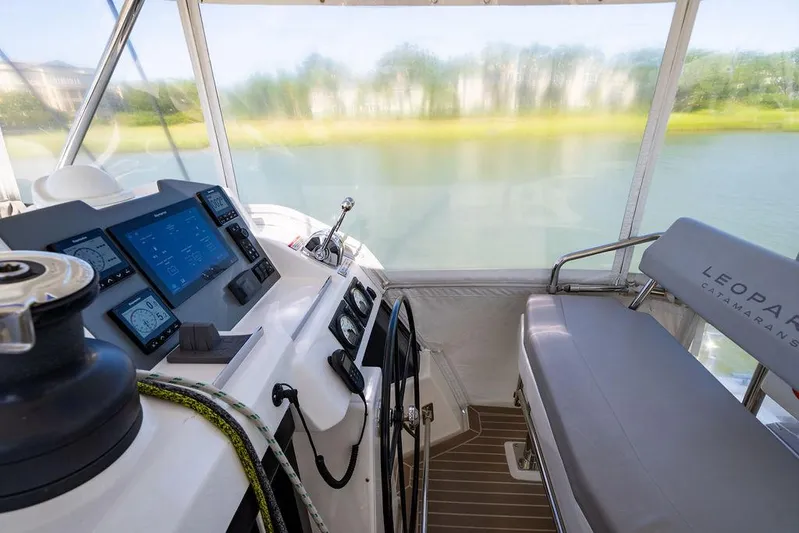 Scooby Yacht Photos Pics Interior of a 2022 Leopard 50 catamaran cockpit with navigation controls and seating.