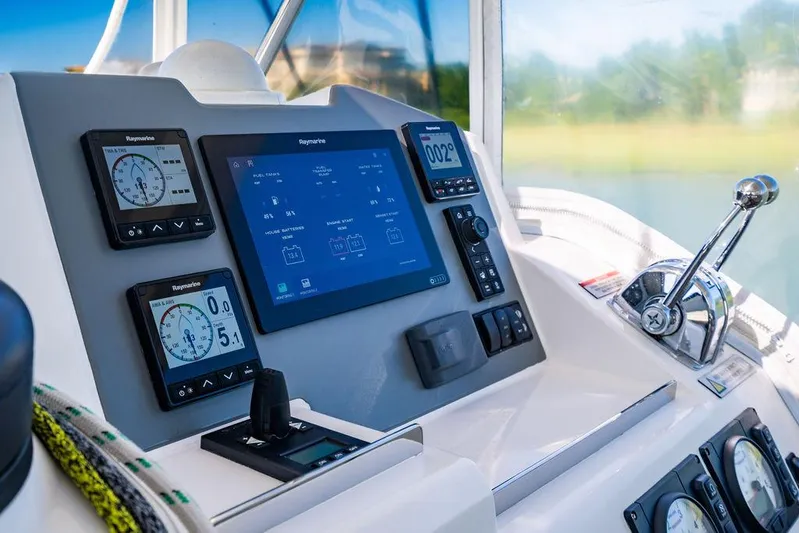 Scooby Yacht Photos Pics Control panel of a 2022 Leopard 50 yacht with navigation displays and throttle lever.