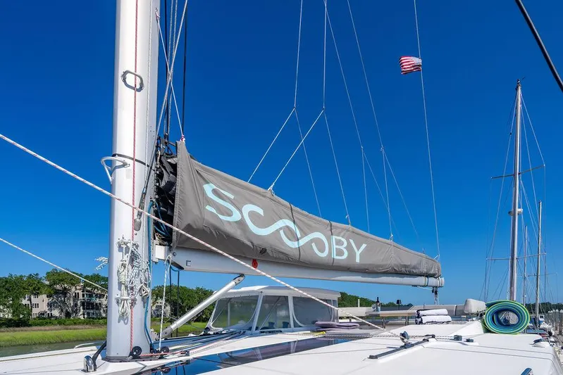 Scooby Yacht Photos Pics Sailboat with "SCOOBY" sail, Leopard 50 model, 2022, under clear blue sky.
