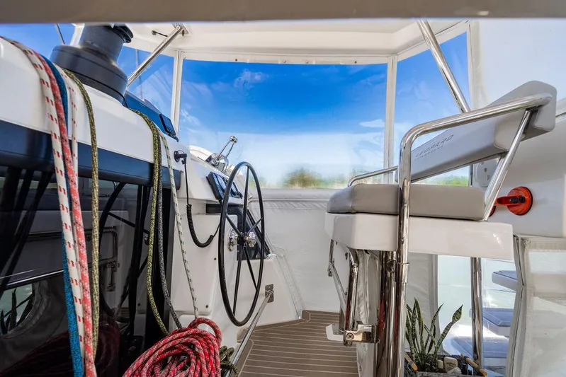 Scooby Yacht Photos Pics Helm of 2022 Leopard 50 yacht with ropes and steering wheel.
