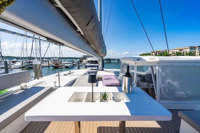 Scooby Yacht Photos Pics Luxurious Leopard 50 yacht deck with table, wine, and marina view, 2022 model.