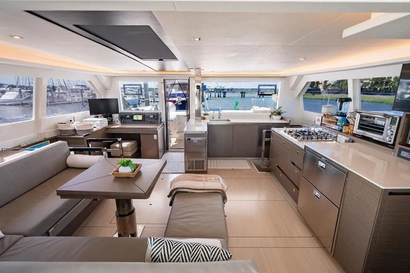 Scooby Yacht Photos Pics Luxurious interior of 2022 Leopard 50 yacht with modern kitchen and spacious seating area.