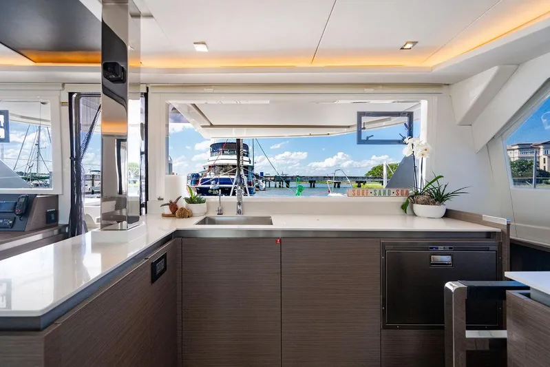 Scooby Yacht Photos Pics Modern kitchen interior on a 2022 Leopard 50 yacht, featuring sleek design and marina view.