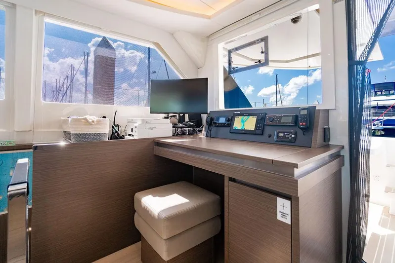 Scooby Yacht Photos Pics Modern navigation station on a 2022 Leopard 50 yacht with electronic equipment and seating.