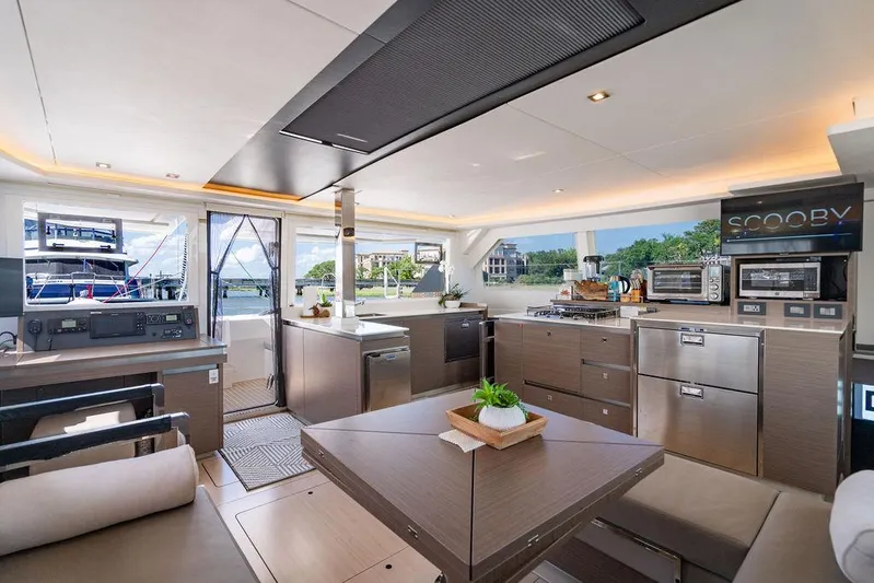 Scooby Yacht Photos Pics Luxurious interior of 2022 Leopard 50 yacht with modern kitchen and dining area.