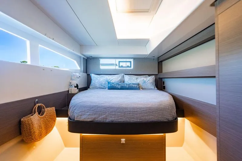 Scooby Yacht Photos Pics Luxurious bedroom interior of 2022 Leopard 50 yacht with modern design and ambient lighting.