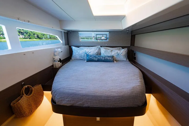 Scooby Yacht Photos Pics Luxurious cabin interior of 2022 Leopard 50 yacht with cozy bed and scenic window views.