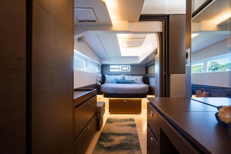 Scooby Yacht Photos Pics Luxurious interior of 2022 Leopard 50 yacht with modern bedroom and elegant wood finishes.