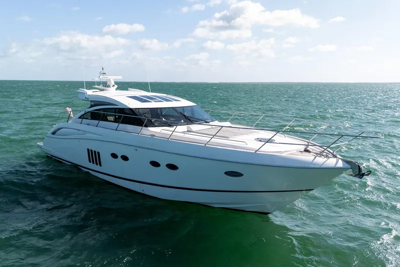 Luna Yacht Photos Pics Luxurious 2009 Princess V62 yacht cruising on open sea under clear skies.