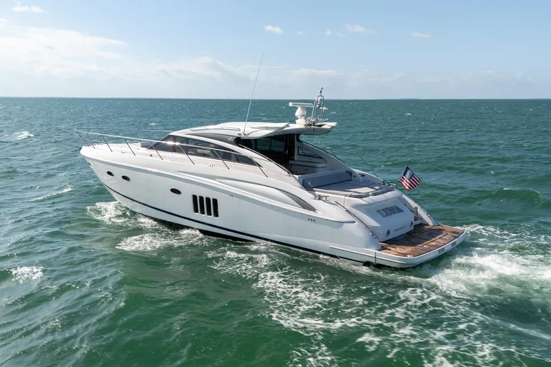 Luna Yacht Photos Pics 2009 Princess V62 yacht cruising on open sea with American flag.