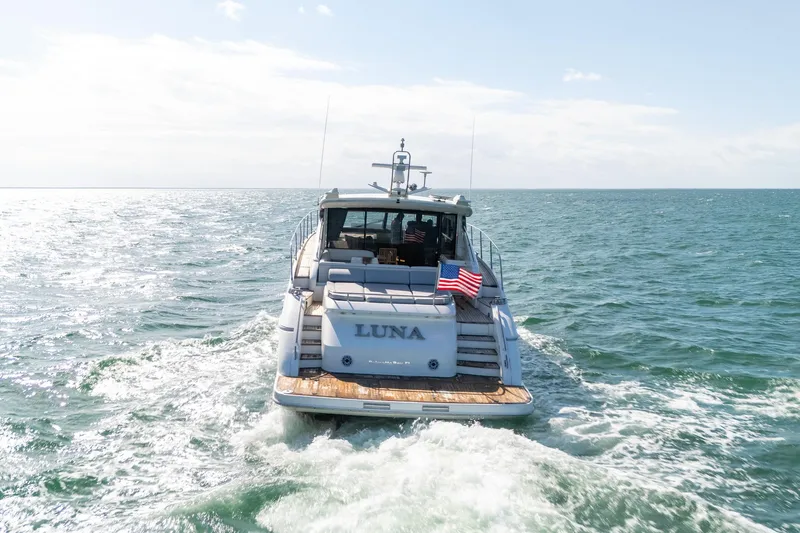 Luna Yacht Photos Pics 2009 Princess V62 yacht "Luna" cruising on open sea with American flag.