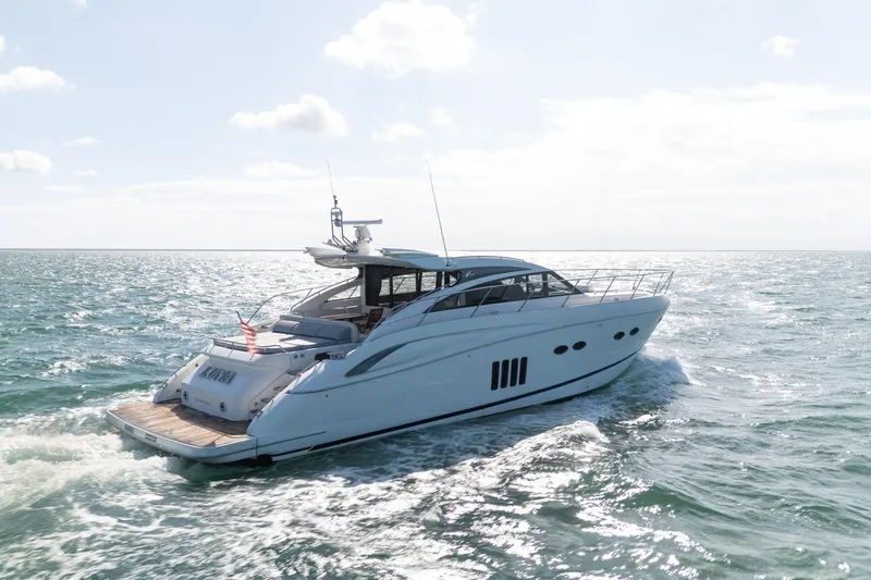 Luna Yacht Photos Pics Luxurious 2009 Princess V62 yacht cruising on open sea under clear skies.