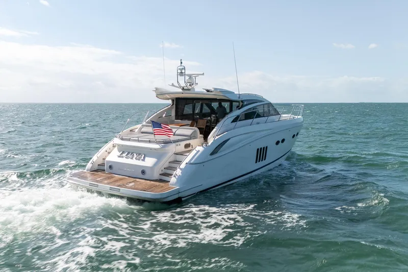 Luna Yacht Photos Pics Luxurious 2009 Princess V62 yacht cruising on open sea with American flag.