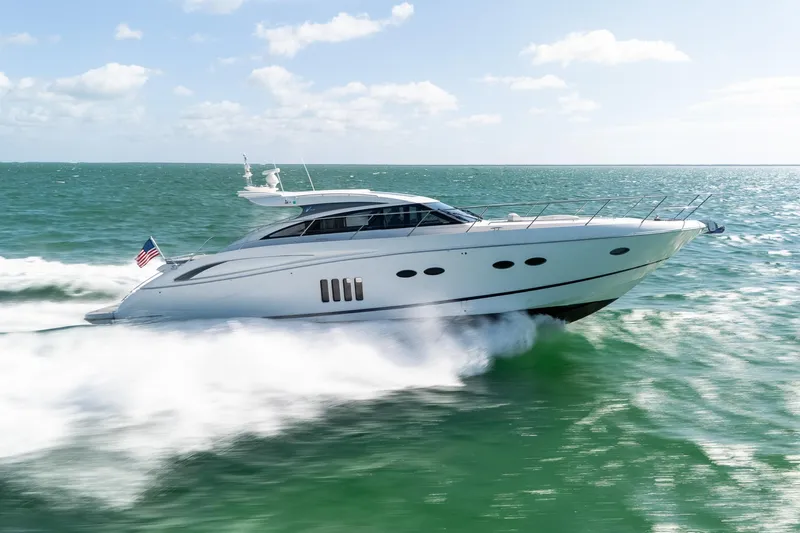 Luna Yacht Photos Pics Luxury 2009 Princess V62 yacht cruising on open sea with American flag.