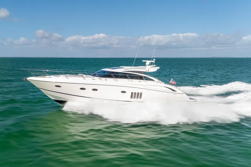 Luna Yacht Photos Pics Luxurious 2009 Princess V62 yacht cruising on open sea under clear skies.