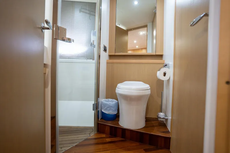 Luna Yacht Photos Pics Luxurious bathroom in 2009 Princess V62 yacht with modern fixtures and wooden flooring.