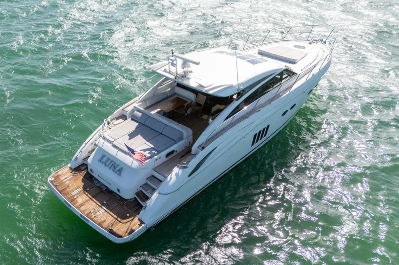 Luna Yacht Photos Pics 2009 Princess V62 yacht "Luna" cruising on sparkling green water.